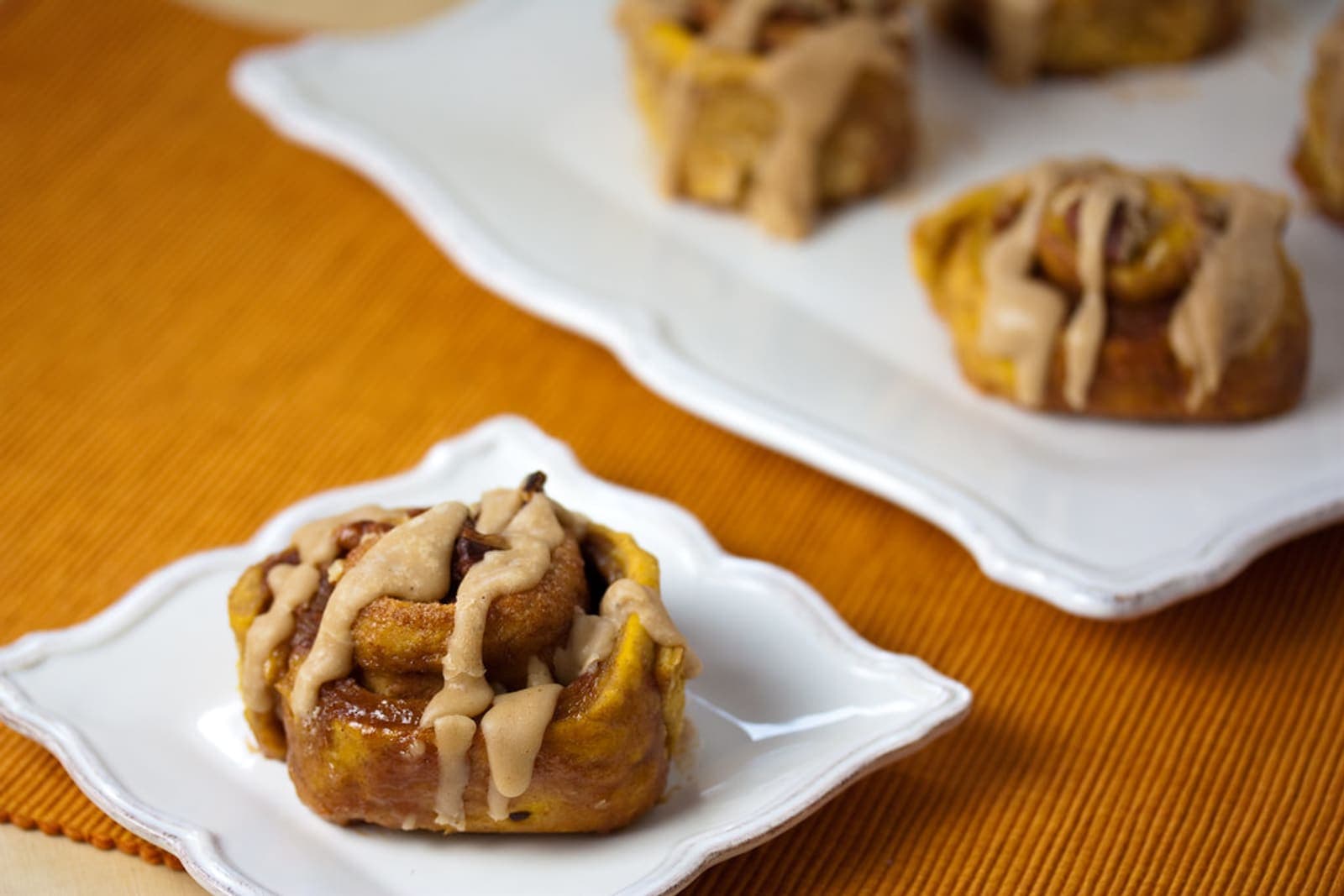 A cinnamon roll drizzled with a simple butter-and-sugar icing.