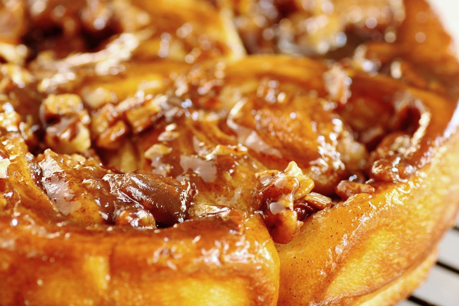 Sticky pecan-topped rolls with a deep maple-caramel glaze.