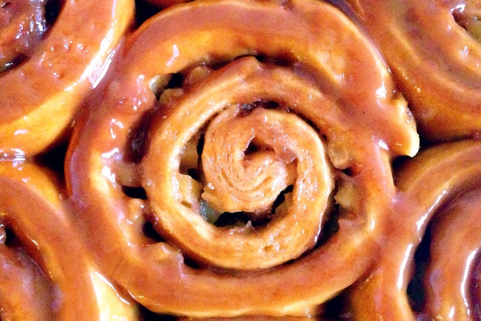 Caramel-glazed roll spirals with a glossy, rich finish.