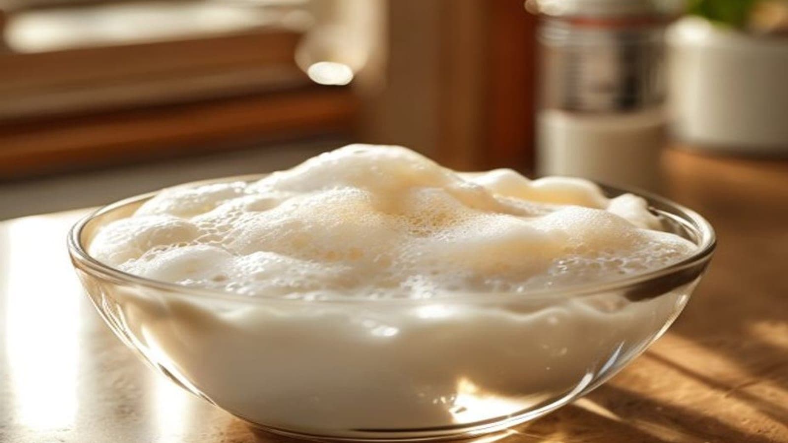 A bowl of foamy activated yeast blooming in warm milk, proving it is alive.