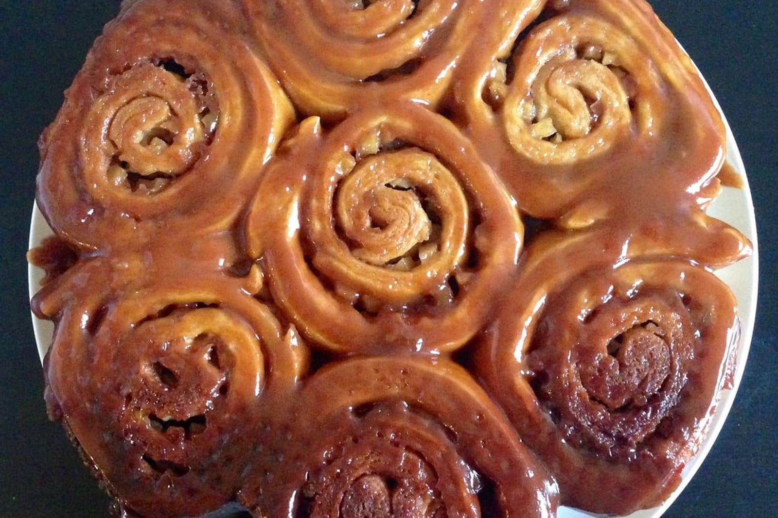 pumpkin cinnamon rolls in a baking dish (AI-generated editorial image)