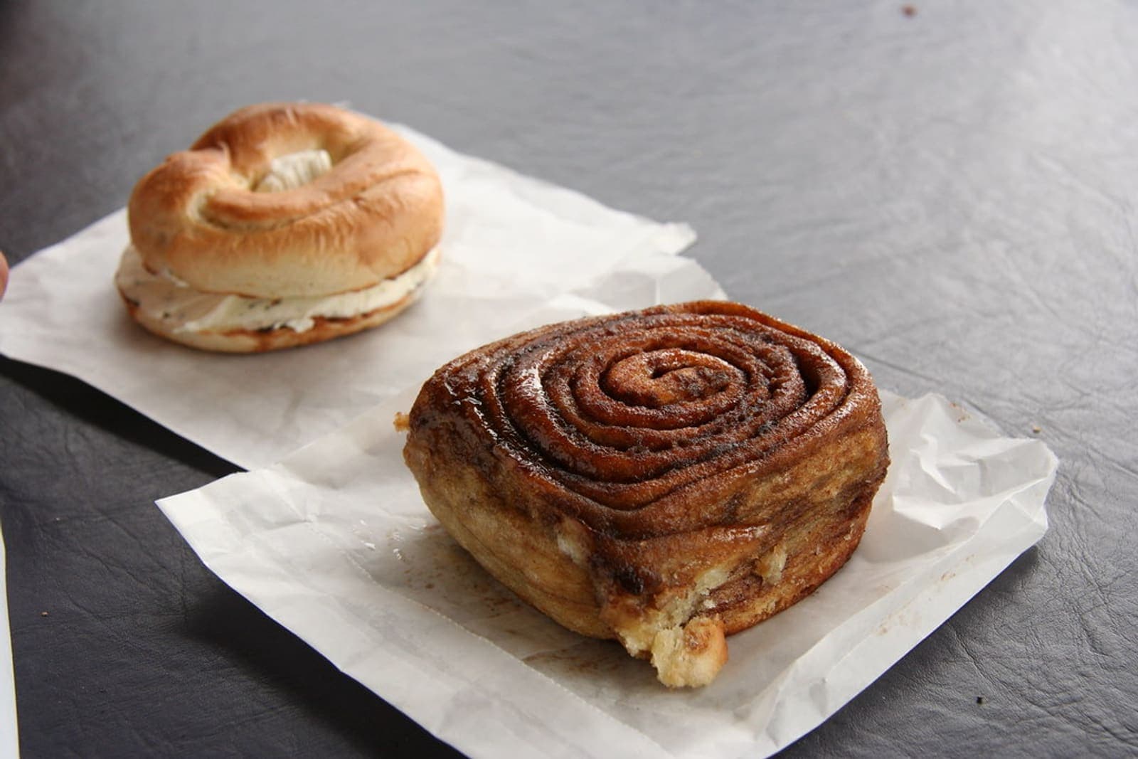 rustic sourdough cinnamon rolls with an artisan open crumb (AI-generated editorial image)